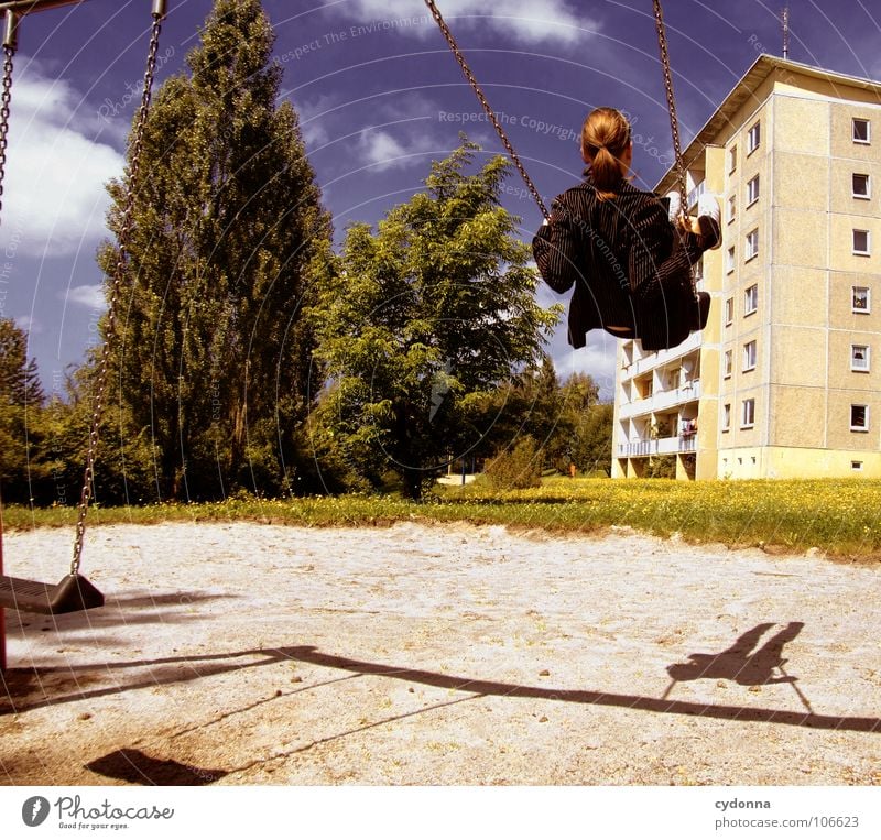 Sitting here, thinking 'bout yesterday Schaukel Wohnhochhaus Wohnsiedlung Plattenbau Osten schön Spielplatz Frau genießen Erholung Leichtigkeit Denken Glück