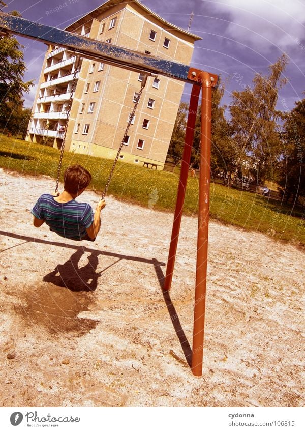 Sitting here, thinking 'bout yesterday V Schaukel Wohnhochhaus Wohnsiedlung Plattenbau Osten schön Spielplatz Mann genießen Erholung Leichtigkeit Denken Glück