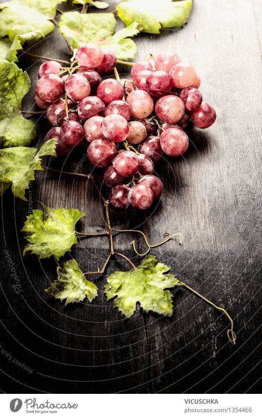 Weintrauben mit Blättern auf rustikalem Holtisch Lebensmittel Frucht Ernährung Bioprodukte Vegetarische Ernährung Diät Saft Design exotisch Gesunde Ernährung