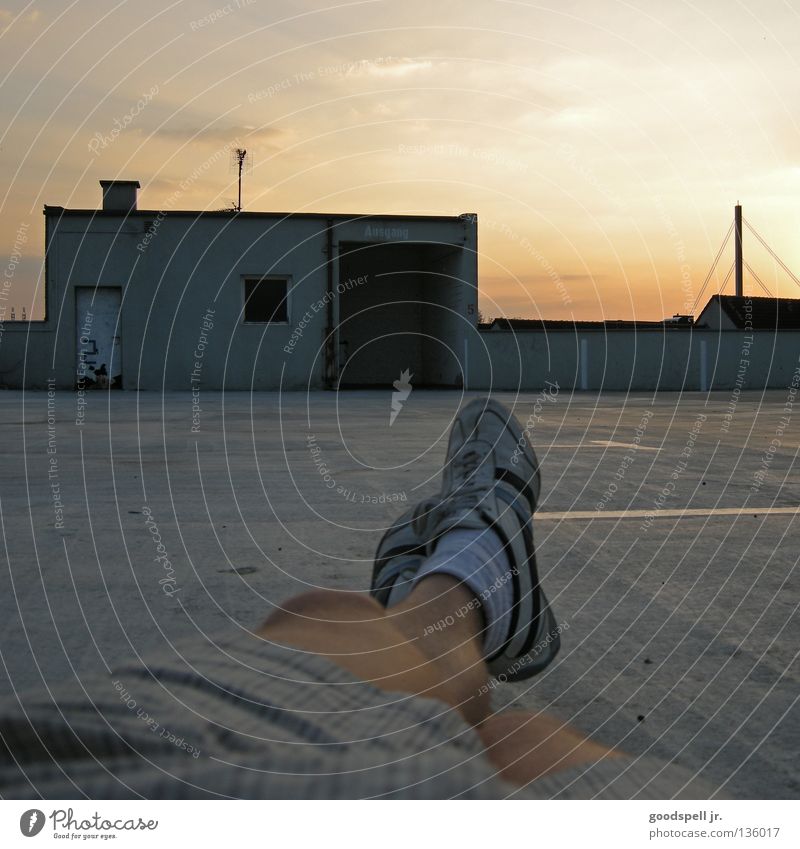 sonnendeck Erholung faulenzen Abenddämmerung Parkhaus Parkdeck liegen Himmel Parkplatz Egoperspektive Turnschuh Feierabend lässig luftig Füße hoch