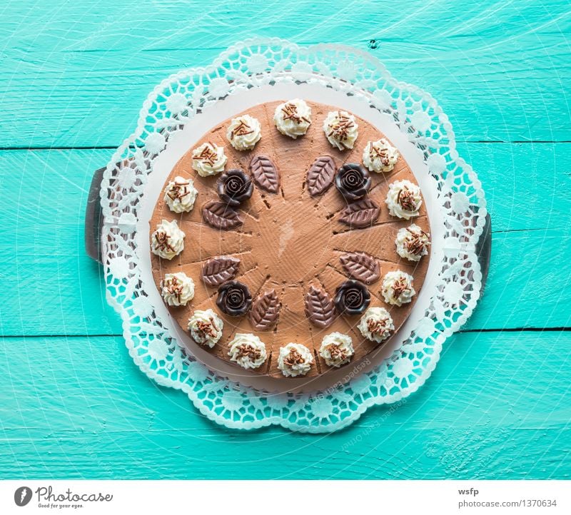 Schokosahnetorte auf türkisem Holz mit Tortenspitze Kuchen Dessert Schokolade Schokoladen-Sahne-Torte Schaumgebäck Backwaren Biskuit Holztisch Landhaus rustikal