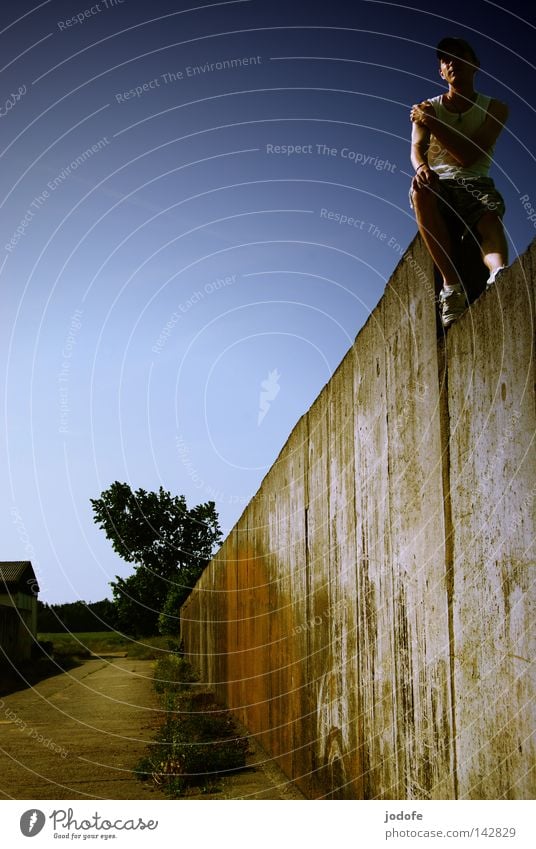 lonesome Mauer Mann maskulin Lebewesen Baum Sträucher Haus Sommer Physik heiß Sonnenlicht Sonnenstrahlen hoch Höhenunterschied Erholung Baseballmütze stark