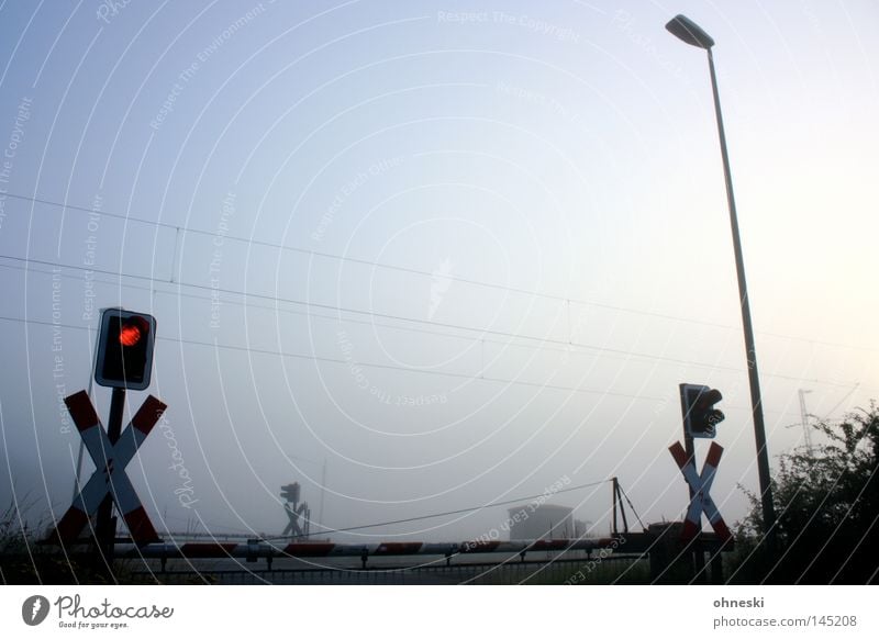 Früh geschlossen Bahnübergang Ampel Nebel Himmel Morgen Schranke Laterne Lampe Sträucher Andreaskreuz Frieden ruhig Sommer Oberleitung Eisenbahn