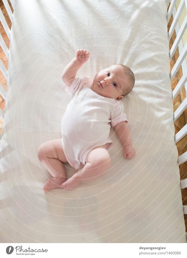 Baby in einem Babybett Glück Gesicht Leben Kind Mädchen Lächeln schlafen klein weich weiß Bett neugeboren lügen reizvoll Kaukasier heimwärts wndow Licht