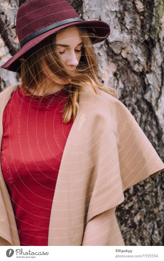 Frau, die auf dem Parkhintergrund mit Blumen steht elegant Stil schön Garten Mensch Mädchen Erwachsene Natur Wetter Tulpe Mode Bekleidung Pullover Pelzmantel