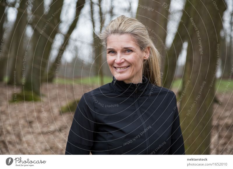 Porträt einer attraktiven Frau im Freien Lifestyle Glück Zufriedenheit Winter Mensch Erwachsene Natur Baum Park blond Lächeln Freundlichkeit Aktion jung heiter