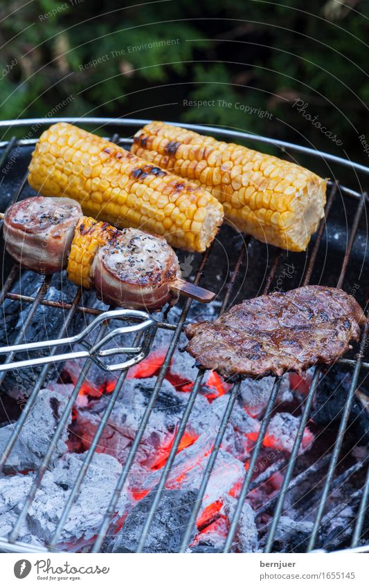 Grilldetail Lebensmittel Fleisch Gemüse Bioprodukte Billig gut heiß gelb grün Grillen Grillrost Maiskolben Glut Kohle Feuer Grillzange aufgespiesst Fleischspieß