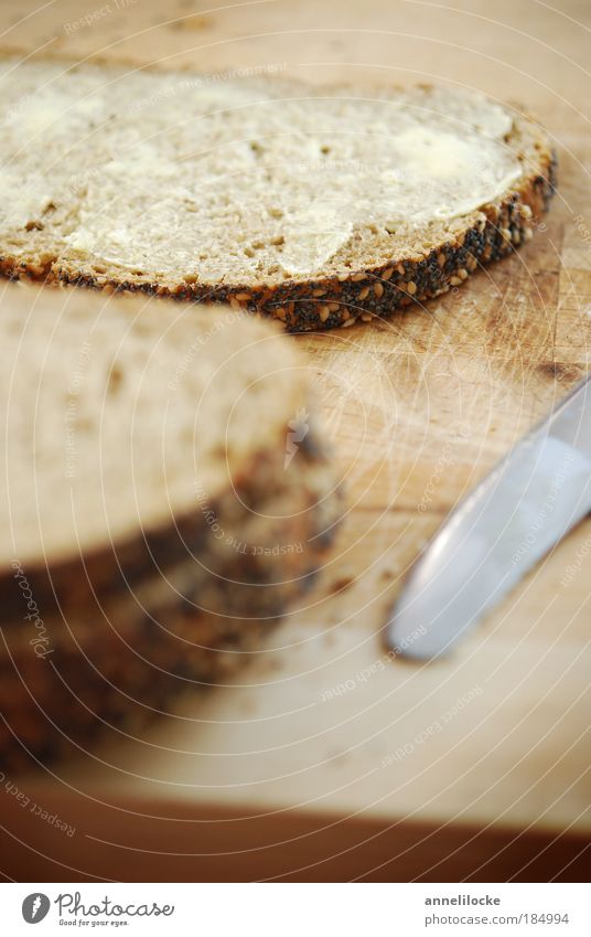 lecker Butterstulle Lebensmittel Brot Mohn Sesam Ernährung Frühstück Abendessen Bioprodukte Vegetarische Ernährung Messer Schneidebrett braun knusprig