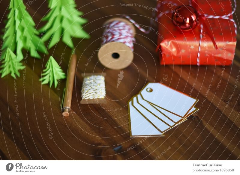 Geschenke verpacken 02 Verpackung Stimmung einpacken beschriften Namensschild Kugelschreiber Geschenkband rot-weiß Tanne Papier gebastelt Holztisch