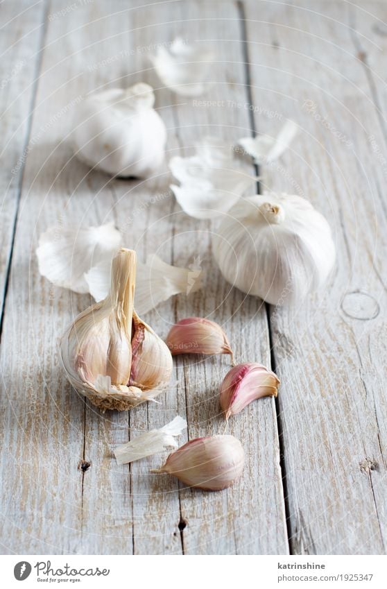 Organischer Knoblauch auf dem alten Holztisch Gemüse Kräuter & Gewürze Vegetarische Ernährung Tisch frisch grau weiß Verfall Knolle Gewürznelke Lebensmittel