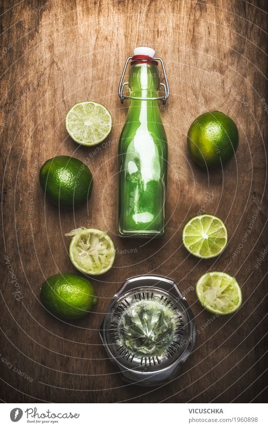 Limettensaft in Flasche mit Früchten und Saftpresse Lebensmittel Frucht Ernährung Bioprodukte Vegetarische Ernährung Diät Getränk Geschirr Stil Design