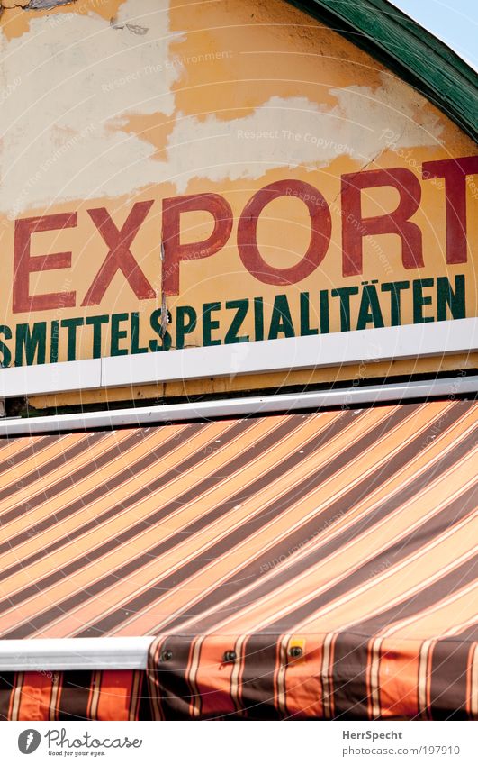 Import Export Lebensmittel braun gelb Markt Markise verkaufen Spezialitäten Güterverkehr & Logistik orange Farbfoto Außenaufnahme Menschenleer Textfreiraum oben