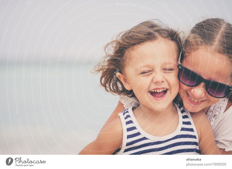 Schwester und Bruder, die am Strand zur Tageszeit spielen. Lifestyle Freude Glück schön Erholung Freizeit & Hobby Spielen Ferien & Urlaub & Reisen Freiheit