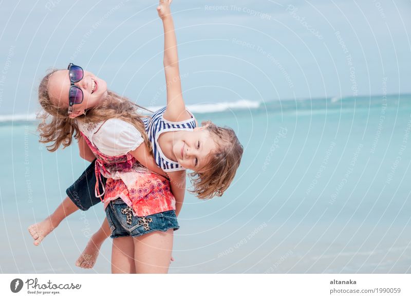 Schwester und Bruder, die am Strand zur Tageszeit spielen. Lifestyle Freude Glück schön Erholung Freizeit & Hobby Spielen Ferien & Urlaub & Reisen Freiheit