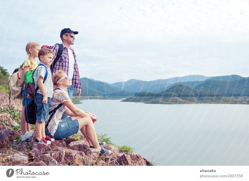 Glückliche Familie, die nahe dem See zur Tageszeit steht. Gesundheit wandern Mensch Kind Frau Erwachsene Mann Eltern Mutter Vater Bruder Schwester Freundschaft