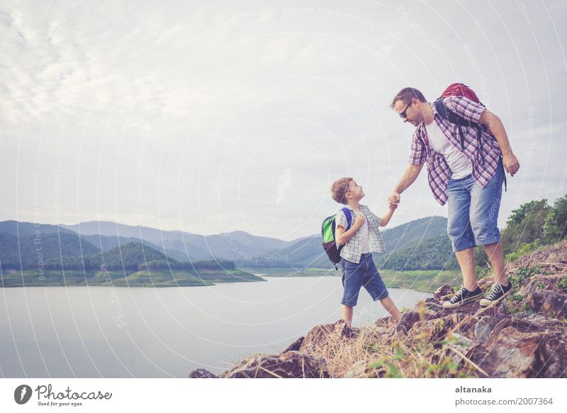 Vater und Sohn, die nahe dem See zur Tageszeit stehen. Lifestyle Freude Glück Freizeit & Hobby Ferien & Urlaub & Reisen Ausflug Abenteuer Freiheit Sommer