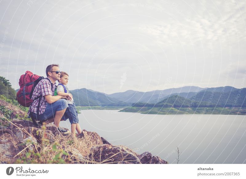 Vater und Sohn, die nahe dem See zur Tageszeit stehen. Lifestyle Freude Glück Freizeit & Hobby Ferien & Urlaub & Reisen Ausflug Abenteuer Freiheit Sommer