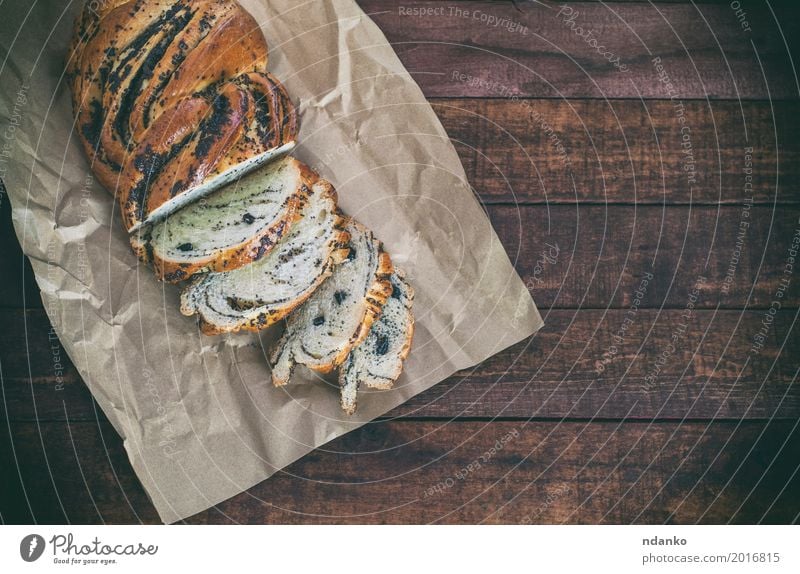 Brötchen mit Mohn auf Kraftpapier Brot Dessert Ernährung Frühstück Abendessen Tisch Papier Holz frisch lecker oben braun schwarz Korn Mahlzeit Scheibe süß Snack