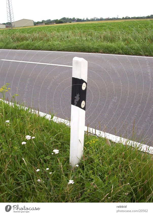 Begrenzungspfahl Pfosten Säule Gras Ebene Hochformat Stranßenrand marschieren