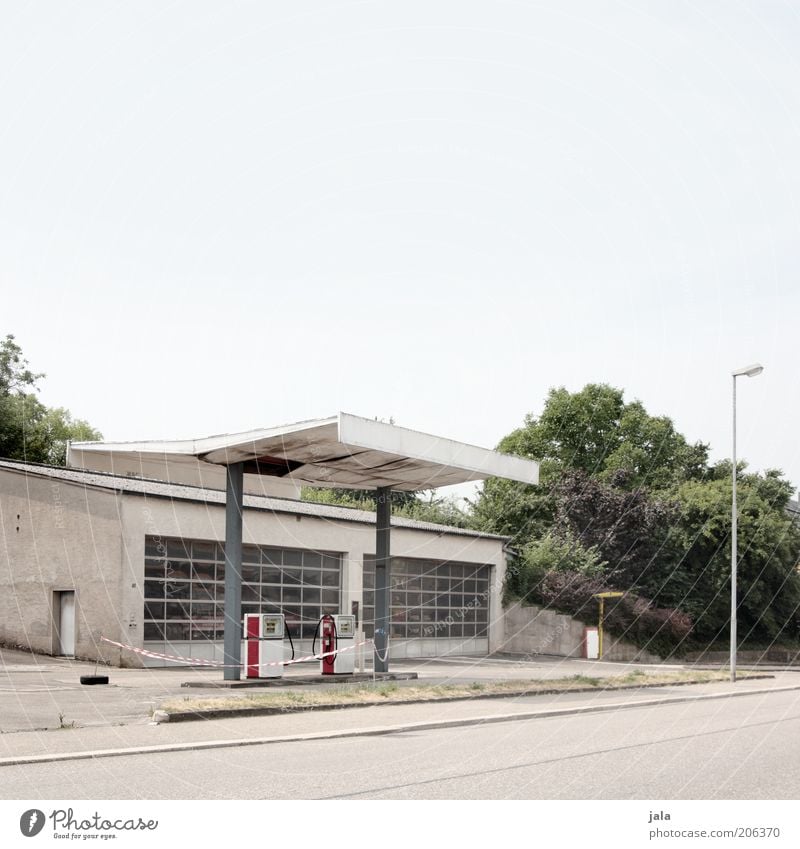 tanke Himmel Pflanze Baum Sträucher Bauwerk Gebäude Architektur Tankstelle Verkehrswege Straße trist Farbfoto Außenaufnahme Menschenleer Textfreiraum oben Tag