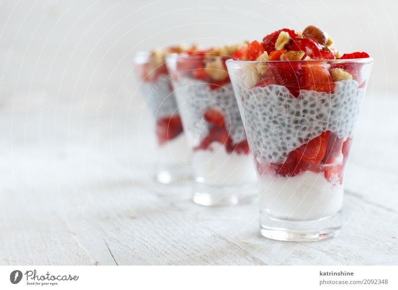 Chia Pudding Erdbeerparfait mit griechischem Joghurt und Nüssen Frucht Dessert Frühstück Diät Glas rot weiß Beeren Müsli Samen Molkerei Feinschmecker