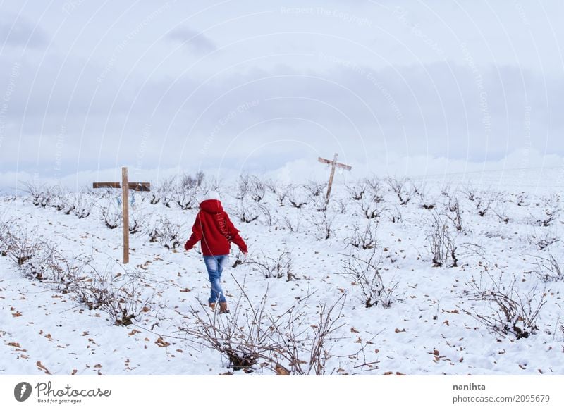 Jemand, der in ein schneebedecktes Feld mit Kreuzen geht Mensch androgyn Jugendliche 1 18-30 Jahre Erwachsene Umwelt Natur Landschaft Himmel Wolken Winter Klima