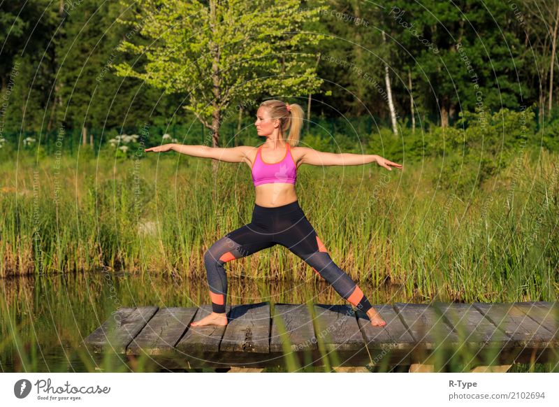 A sporty woman doing yoga and stretching exercises Lifestyle Wellness Sport Yoga Mensch Frau Erwachsene Natur Park Mode blond Fitness Aerobics active athlete