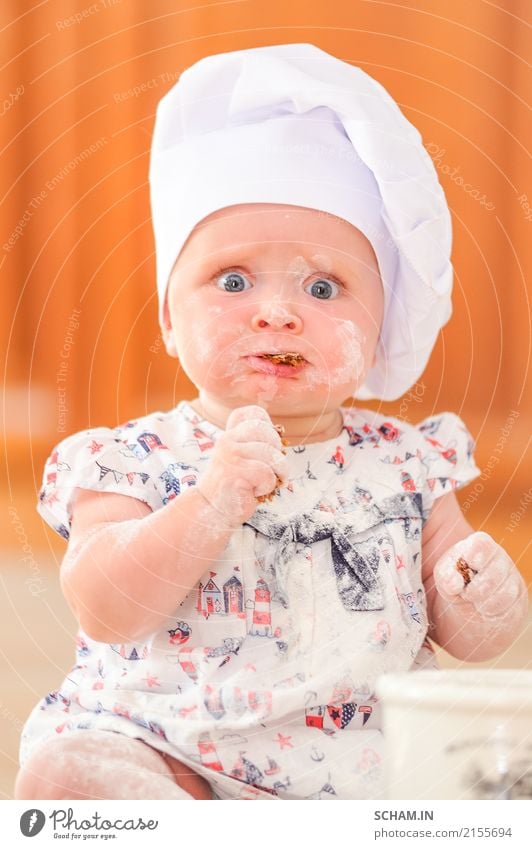 Was für ein Look! Nettes liitle Mädchen im Hut des Chefs beschmutzt mit Mehl Lebensmittel Gemüse Brot Kuchen Essen Frühstück Mittagessen Lifestyle Freude