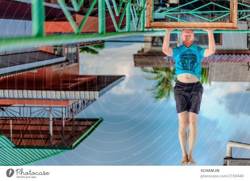 Turned upside down picture: yoga teacher portrait. Red hair man with a red beard showing headstand. Lifestyle Erholung Meditation Sport Yoga Erwachsene sitzen