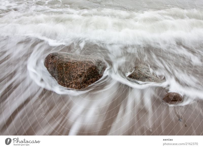 Steine in der Brandung Tourismus Strand Meer Wellen Umwelt Natur Klimawandel Küste Nordsee Ostsee kalt maritim braun weiß fließen Felsen Farbfoto Außenaufnahme