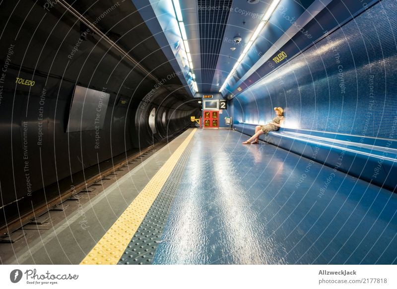 Frau sitzt in der U-Bahn und wartet feminin sitzen warten Hut Kleid Verkehr Öffentlicher Personennahverkehr Fliesen u. Kacheln Untergrund Gleise