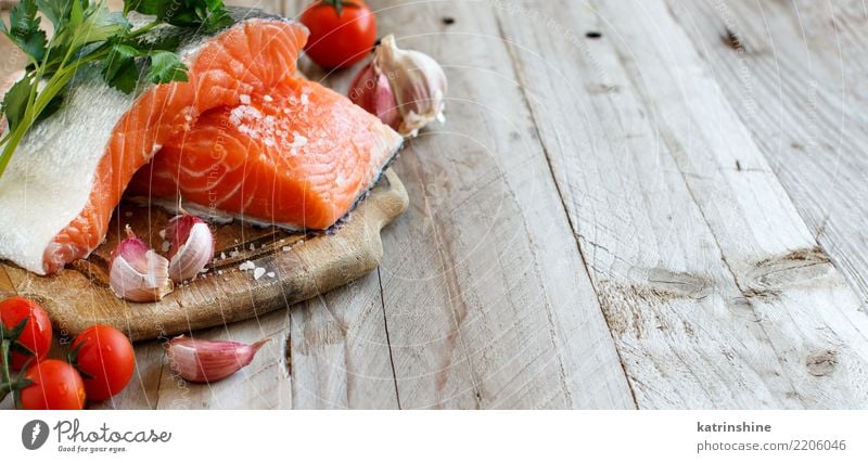 Frische rohe Lachse auf einem hölzernen Schneidebrett Fisch Gemüse Kräuter & Gewürze Ernährung Essen Abendessen Diät Tisch frisch rot Hintergrund Holzplatte