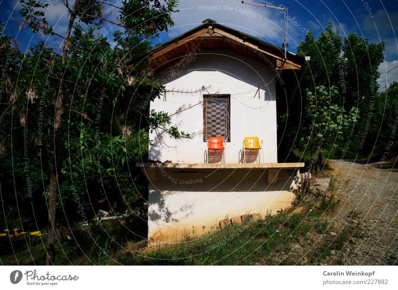 Platz an der Sonne. Stil Design Sommer Sonnenbad Häusliches Leben Haus Stuhl Einfamilienhaus Hütte Hochsitz Mauer Wand Fassade Balkon Terrasse Fenster Erholung