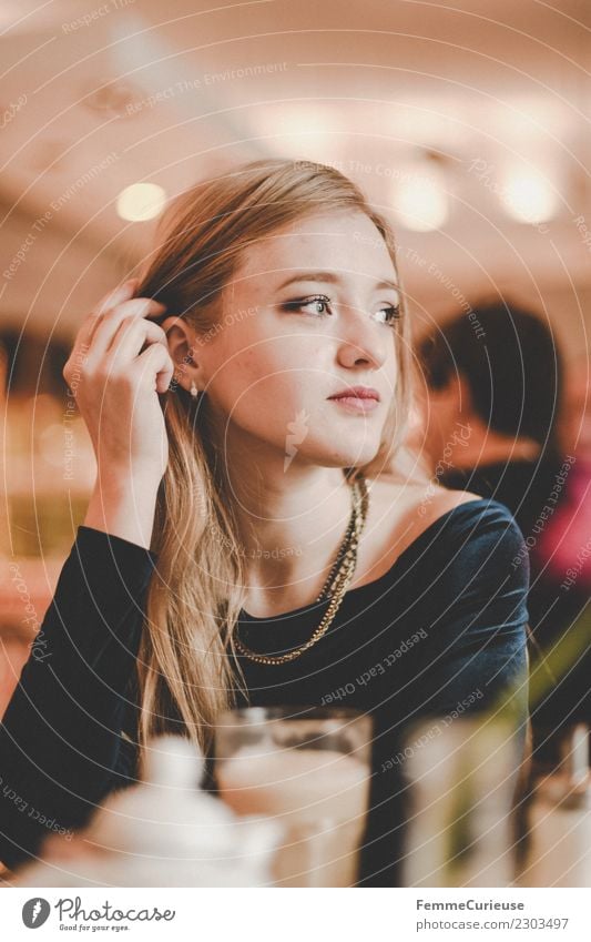 Young woman sitting in a café elegant feminin Junge Frau Jugendliche Erwachsene 1 Mensch 18-30 Jahre schön blond verträumt träumen Mode modern Café Kaffee