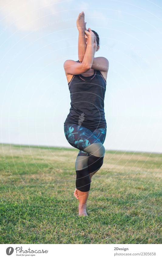 Schönes Mädchen nimmt an Yoga im Park teil Lifestyle harmonisch Erholung Sport Frau Erwachsene Jugendliche Natur Gras sitzen grün Kraft Konzentration