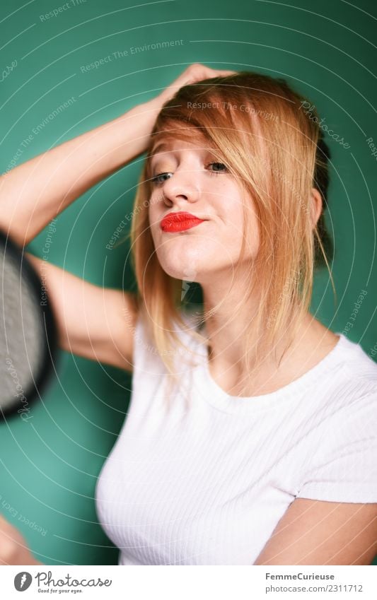 Young woman looking at herself in a hand mirror Lifestyle Stil feminin Junge Frau Jugendliche Erwachsene 1 Mensch 18-30 Jahre schön Haare & Frisuren Haarsträhne