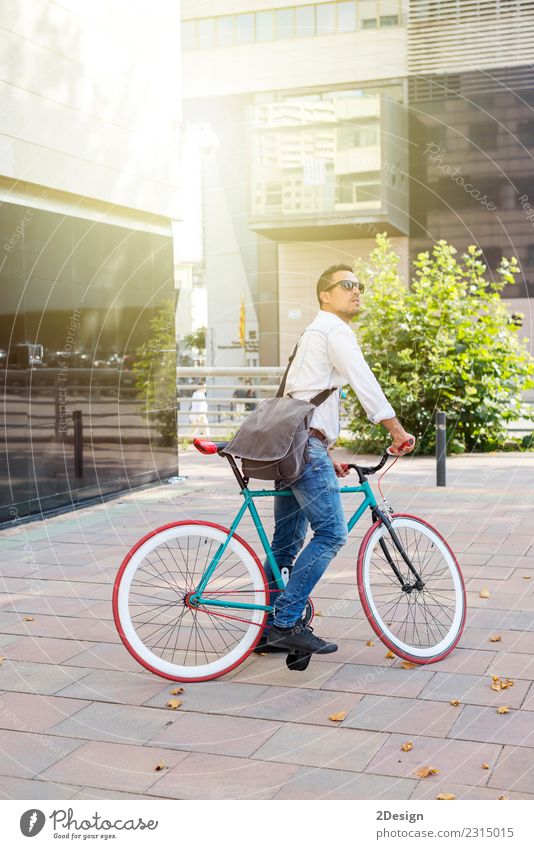 Ein junger, stilvoller Mann, der neben seinem Fahrrad posiert. Erholung Sport Erwachsene Jugendliche Jugendkultur Straße Mode Jeanshose Brille Glatze Lächeln