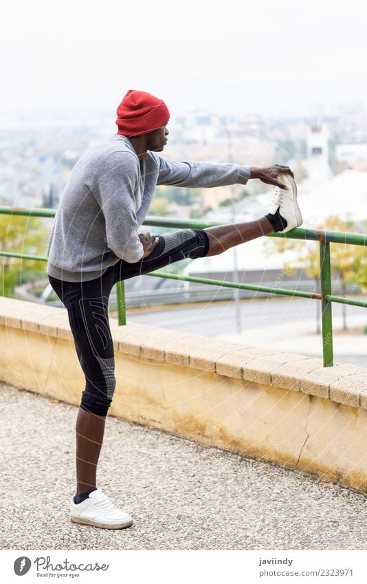 Schwarzer Mann, der sich dehnt, nachdem er im Freien gelaufen ist. Lifestyle Körper Winter Sport Joggen Mensch maskulin Junger Mann Jugendliche Erwachsene 1