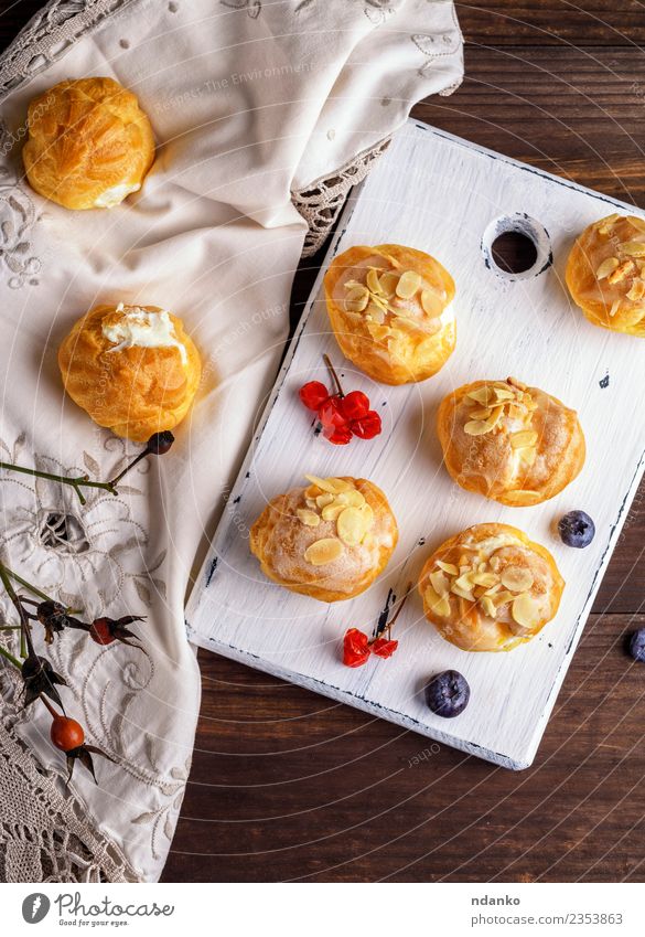 gebackene Profiteroles Lebensmittel Dessert Süßwaren Ernährung Holz frisch lecker weiß Amuse-Gueule Hintergrund Bäckerei Butter Kuchen Essen zubereiten Sahne