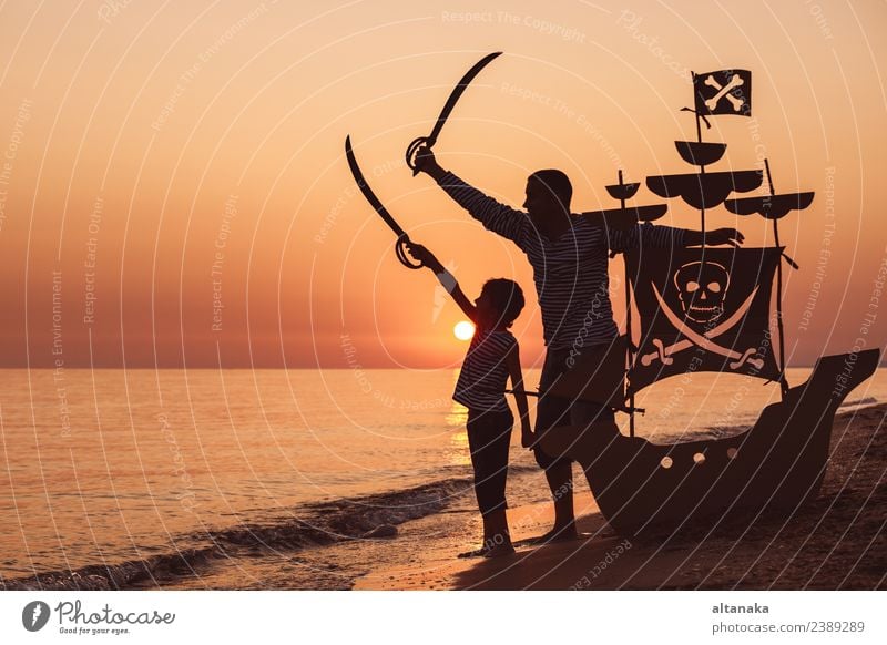 Vater und Sohn spielen am Strand bei Sonnenuntergang. Lifestyle Freude Glück Spielen Ferien & Urlaub & Reisen Ausflug Abenteuer Freiheit Sommer Meer Segeln Kind