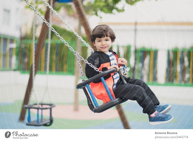 Spielendes Kind Freude Glück Freizeit & Hobby Schule Junge Kindheit Jugendliche Park Spielplatz Pullover Strumpfhose brünett Metall Bewegung Lächeln schaukeln