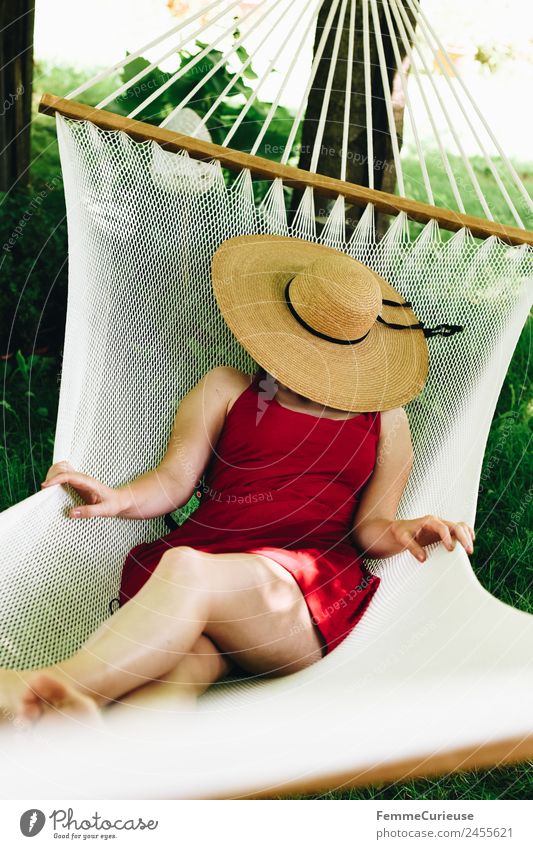 Young woman relaxing in a hammok feminin Junge Frau Jugendliche Erwachsene 1 Mensch 18-30 Jahre 30-45 Jahre Erholung Sonnenhut Hängematte Garten Kleid Sommer