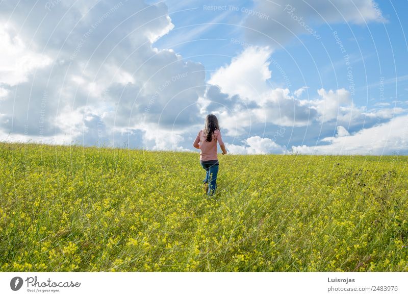 Mädchen, das auf einem Feld mit gelben Blumen spazieren geht, sonniger Tag Freude Gesundheitswesen Wellness Sinnesorgane Erholung Duft Ferien & Urlaub & Reisen