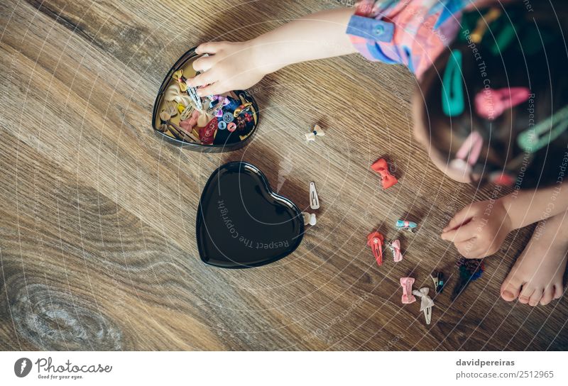 Baby Mädchen spielt mit Haarspangen, die auf dem Boden sitzen. Lifestyle Freude Glück schön Spielen Haus Kind Mensch Frau Erwachsene Kindheit Hand Bekleidung