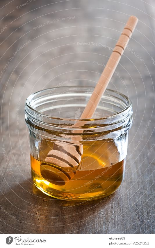 Honigdipper mit Honig im Glas auf Holz Lebensmittel Süßwaren Ernährung Diät Flasche Löffel Gesundheit Gesunde Ernährung Flüssigkeit süß Liebling liquide