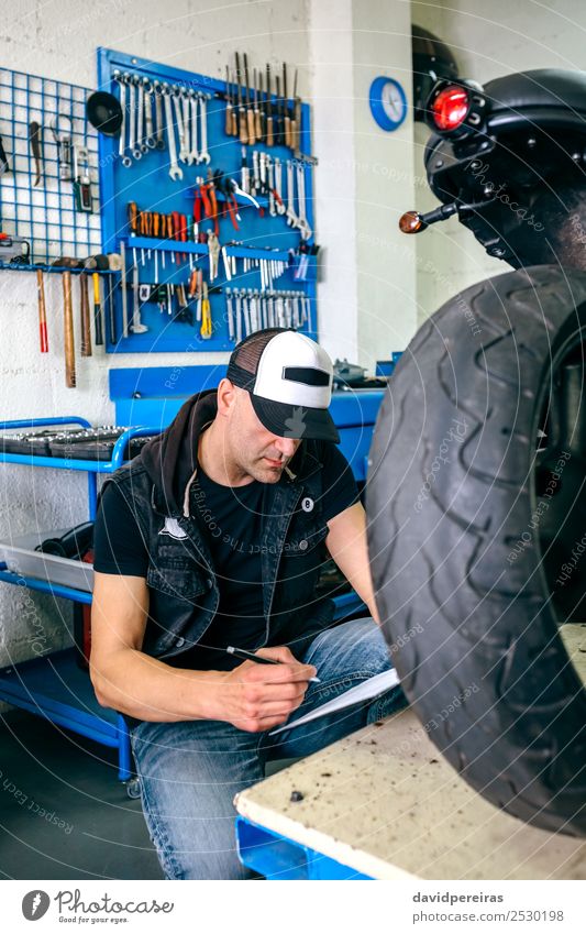 Mechanische Überprüfung des Motorrads Lifestyle Stil Arbeit & Erwerbstätigkeit Mensch Mann Erwachsene Fahrzeug Jeanshose Turnschuh authentisch retro Mechaniker