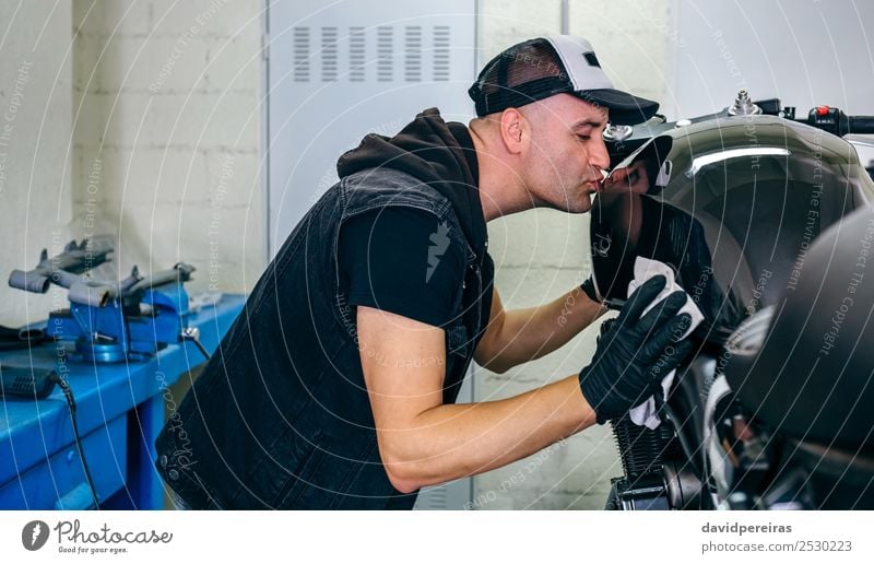 Mechaniker beim Küssen des Motorrads Lifestyle Stil Freizeit & Hobby Mensch Mann Erwachsene Fahrzeug Stoff Liebe authentisch hell lustig retro Leidenschaft