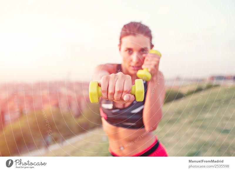 athletische Frau, die im Freien trainiert. Lifestyle schön Sport Erwachsene Fitness sportlich benutzend Hantel Bowle jung üben Training Aktion Gesundheit Kraft