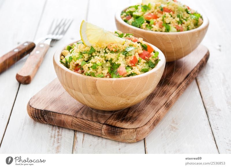 Tabbouleh-Salat mit Couscous auf weißem Tisch Salatbeilage Gemüse Tomate Gurke Salatgurke Petersilie Minze Vegane Ernährung Vegetarische Ernährung Gesundheit