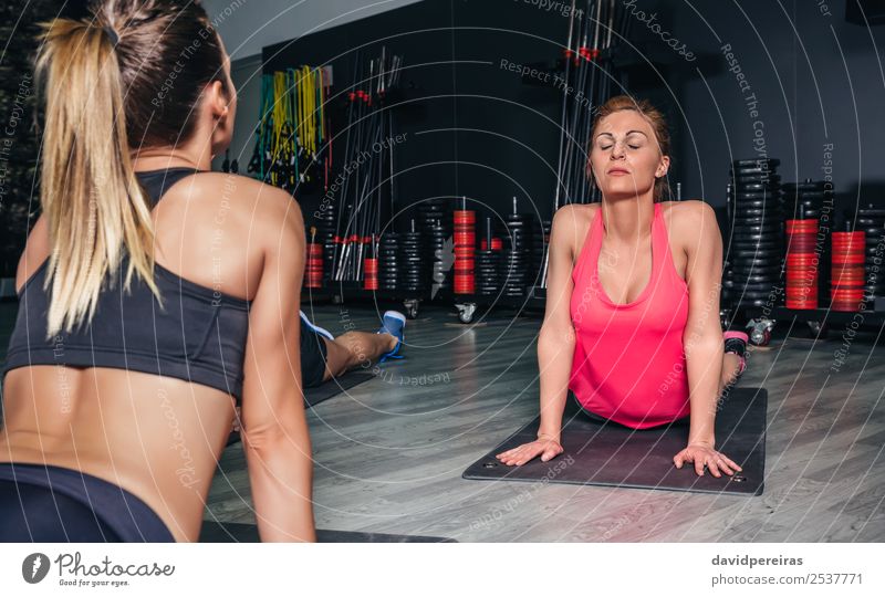 Frau, die sich in einer Fitnessklasse zurückstreckt. Lifestyle Glück schön Körper Sport Schule Erwachsene Arme Menschengruppe rothaarig Zopf authentisch